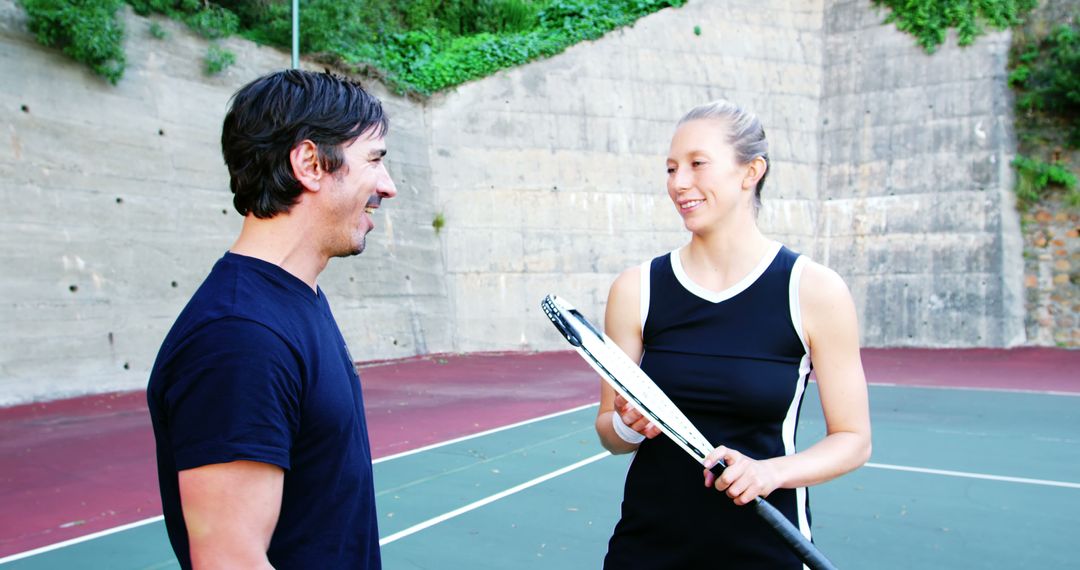 Man and Woman Playing Tennis Outdoor Smiling and Laughing - Free Images, Stock Photos and Pictures on Pikwizard.com