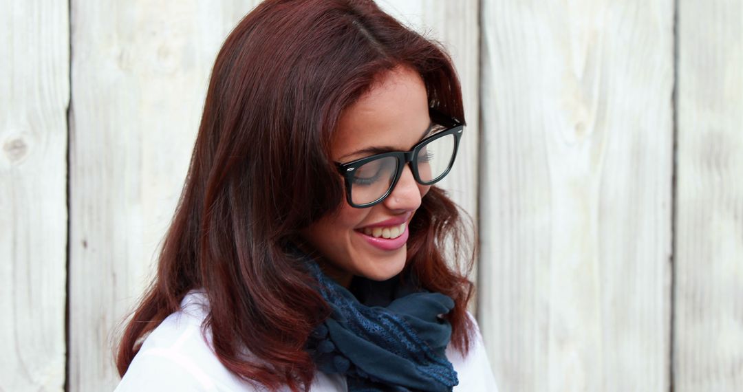 Smiling Woman with Glasses and Scarf Against Wooden Background - Free Images, Stock Photos and Pictures on Pikwizard.com