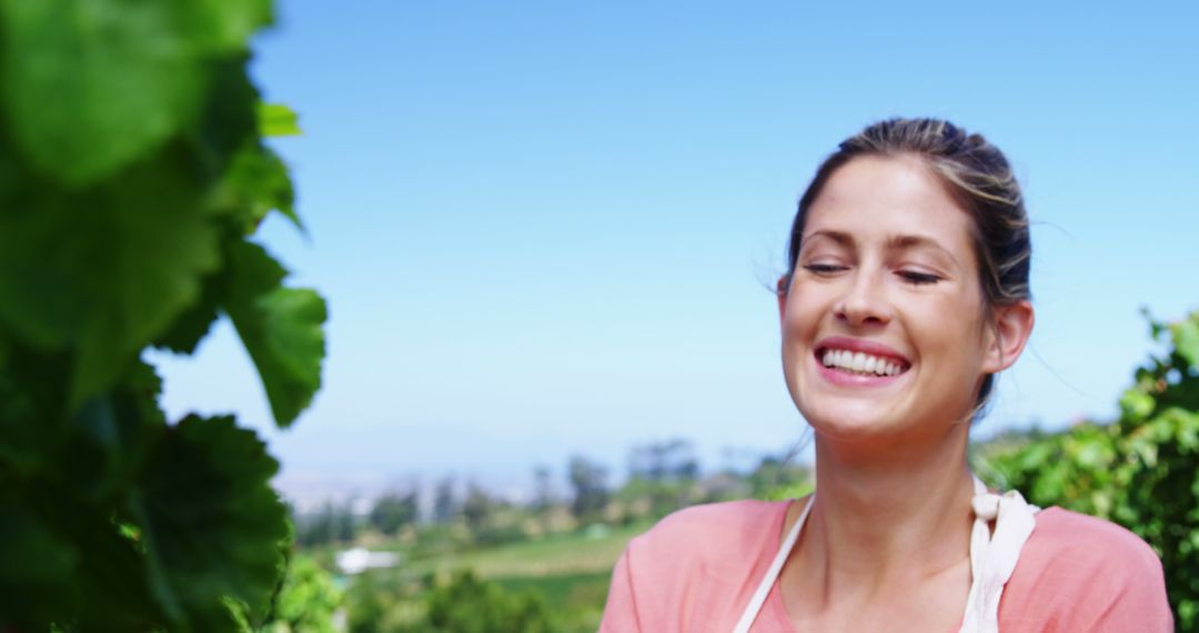 Smiling Woman Enjoying Sunny Day in Vineyard - Free Images, Stock Photos and Pictures on Pikwizard.com