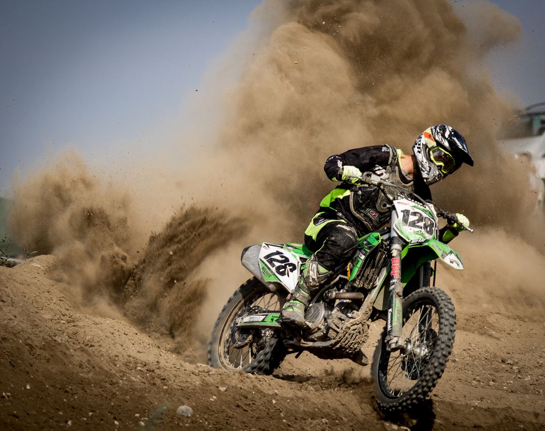 Motorcross Rider Creating Dust Haze During a Race - Free Images, Stock Photos and Pictures on Pikwizard.com