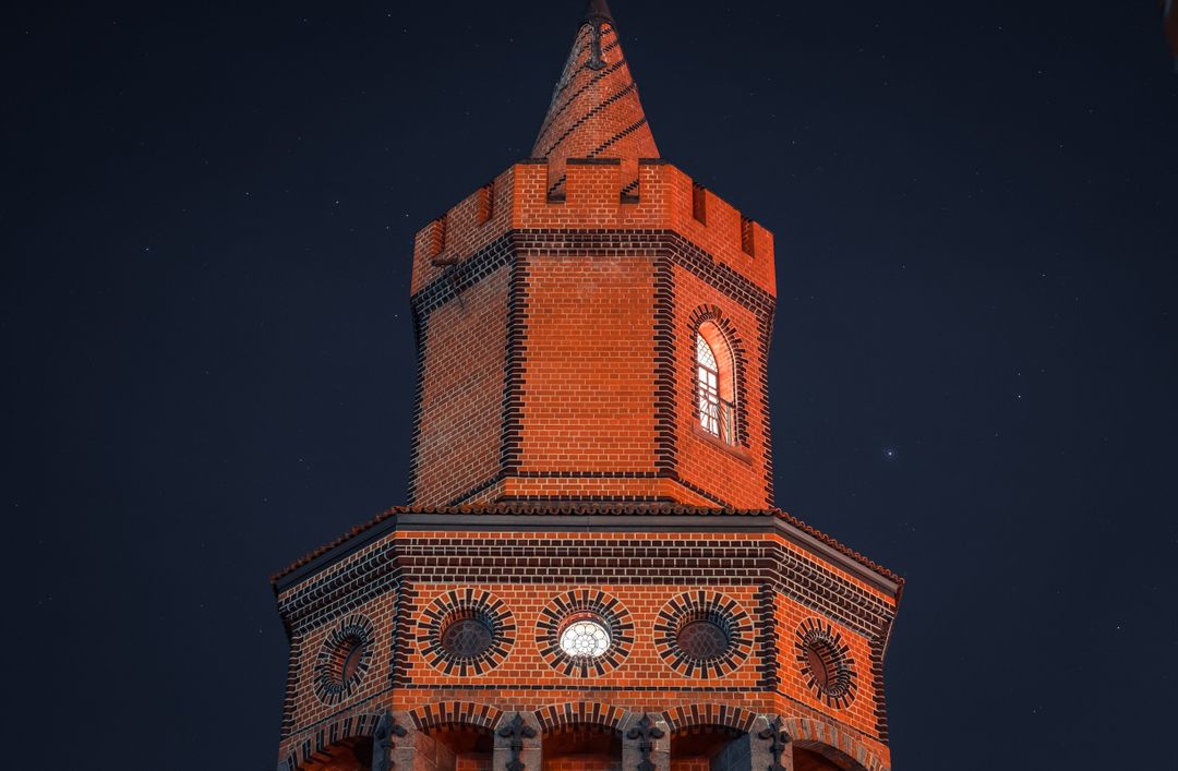 Historic Red Brick Tower Illuminated at Night - Free Images, Stock Photos and Pictures on Pikwizard.com