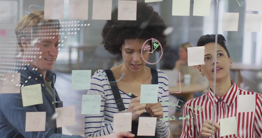 Diverse Team Collaborating on Project with Sticky Notes and Diagrams