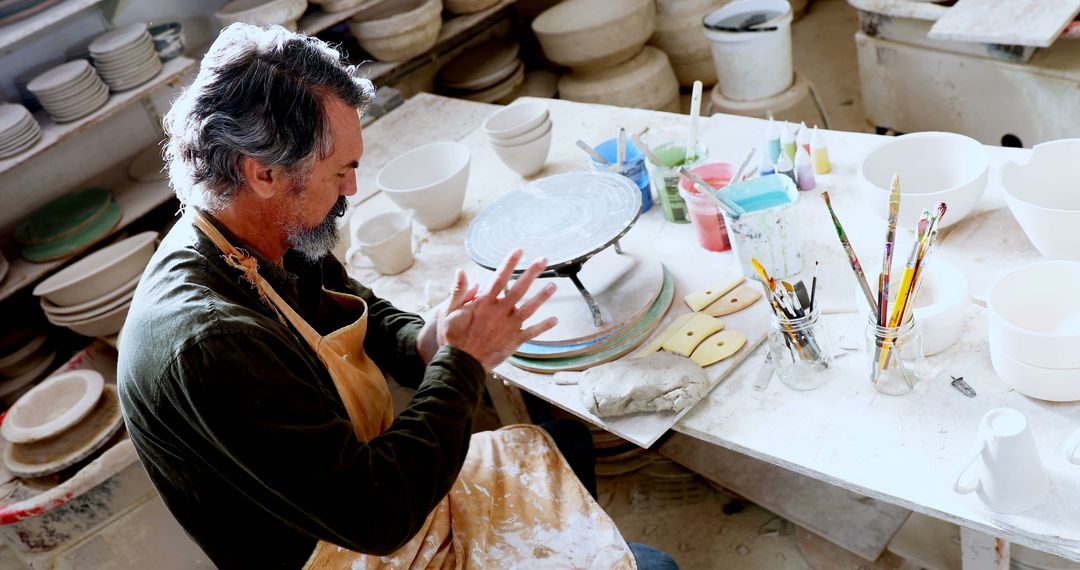 Senior Potter Preparing Clay in Artisan Workshop - Free Images, Stock Photos and Pictures on Pikwizard.com