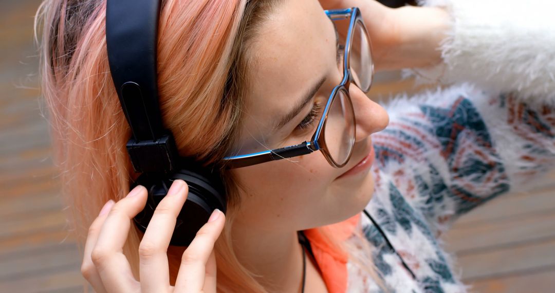 Young Woman with Headphones Enjoying Music Outdoors - Free Images, Stock Photos and Pictures on Pikwizard.com