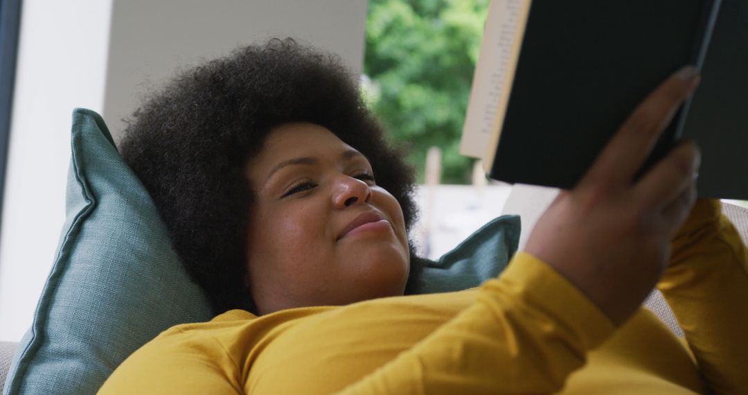 Woman Relaxing on Couch with Book in Hand - Free Images, Stock Photos and Pictures on Pikwizard.com