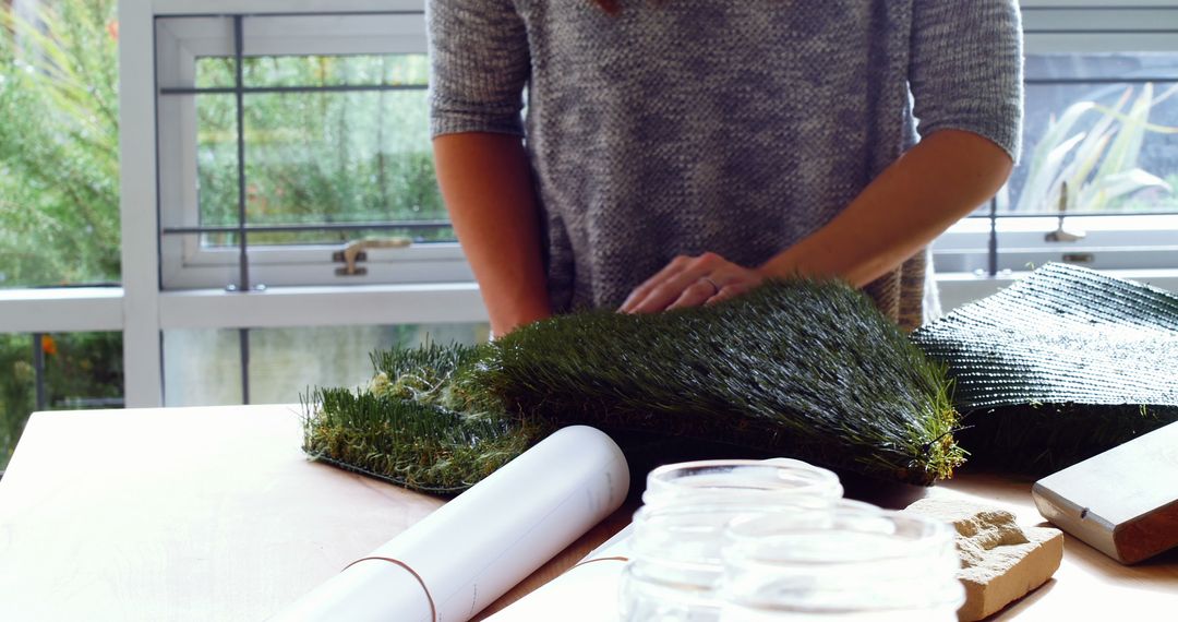 Person Renovating Home Interior with Artificial Grass and DIY Tools - Free Images, Stock Photos and Pictures on Pikwizard.com