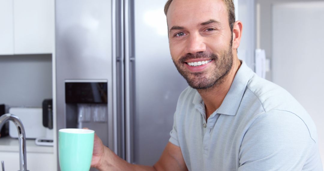 Smiling Man Relaxing at Home with Morning Coffee in Modern Kitchen - Free Images, Stock Photos and Pictures on Pikwizard.com