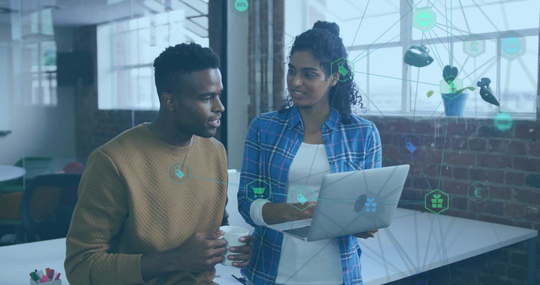 Creative Colleagues Discussing Tech Strategy in Modern Office