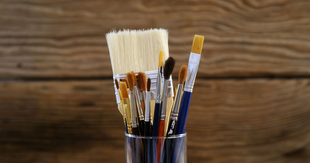 Collection of Various Paint Brushes in Glass Cup on Wooden Background - Free Images, Stock Photos and Pictures on Pikwizard.com