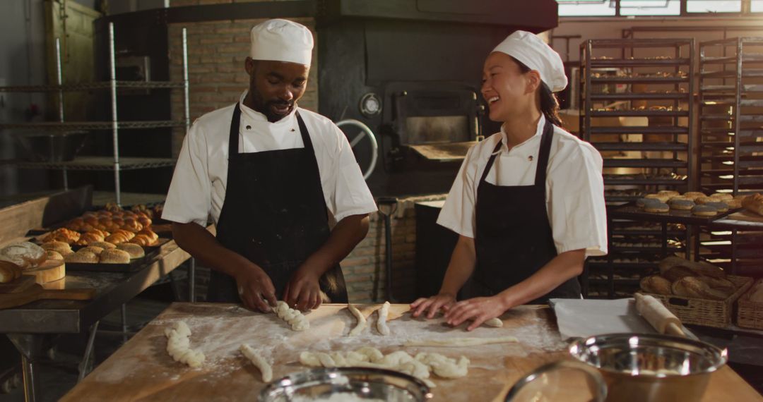 Bakery Chefs Laughing While Preparing Bread Dough in Artisan Bakery - Free Images, Stock Photos and Pictures on Pikwizard.com