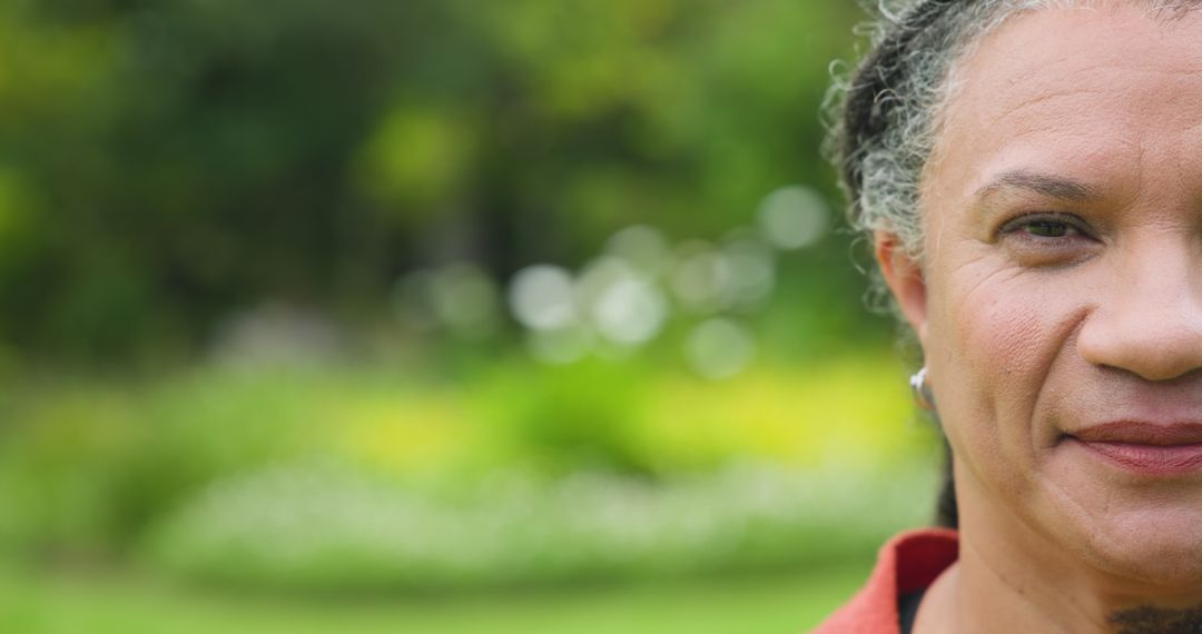 Senior Woman Smiling in Botanical Garden with Soft Light