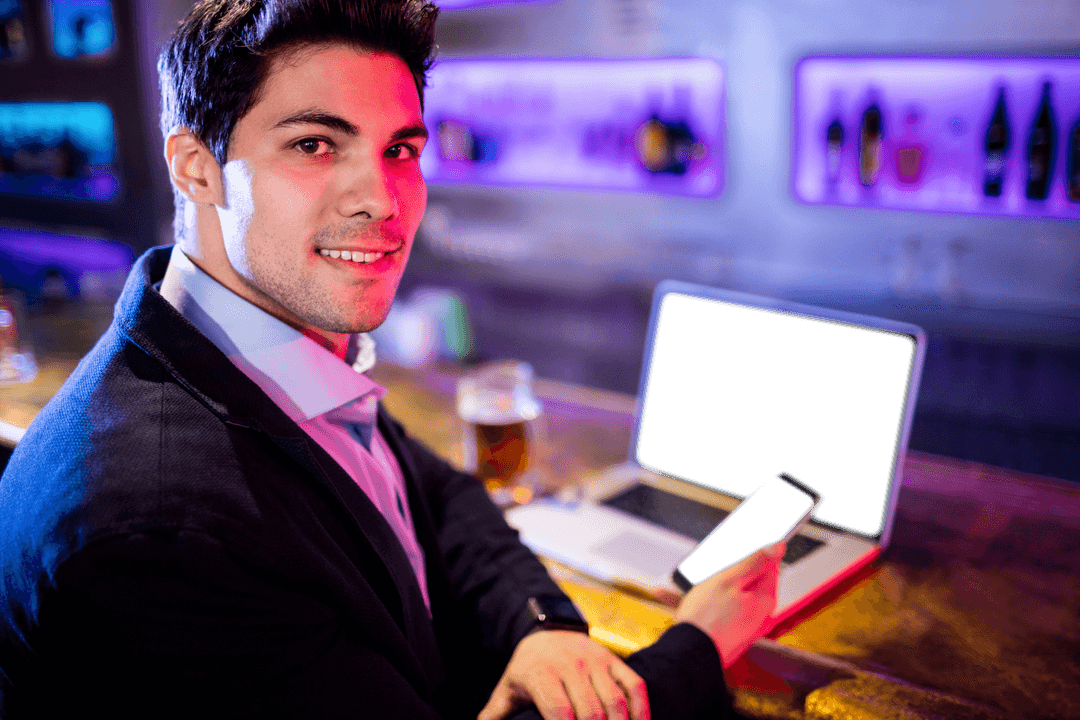 Smiling Businessman Holding Smartphone with Laptop at Bar, Transparent Background