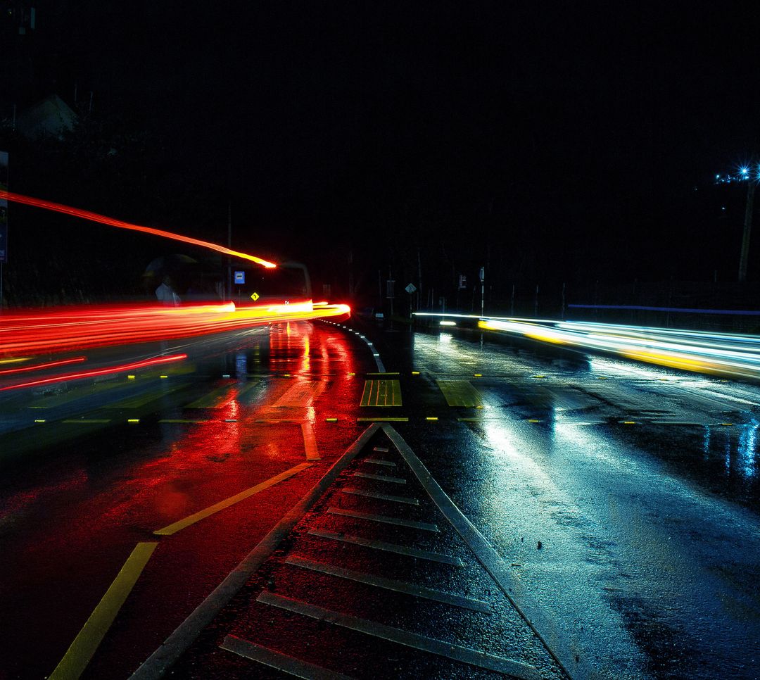 Dynamic Night Traffic with Light Trails on Wet Street