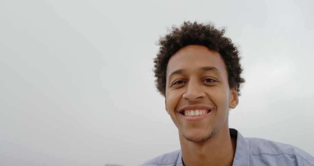 Cheerful Young Man Enjoying Beachfront Day