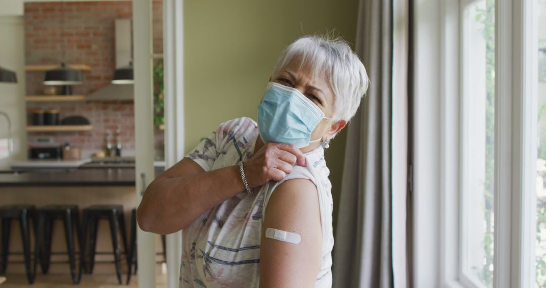 Senior Woman Showing Vaccination Bandage at Home - Free Images, Stock Photos and Pictures on Pikwizard.com