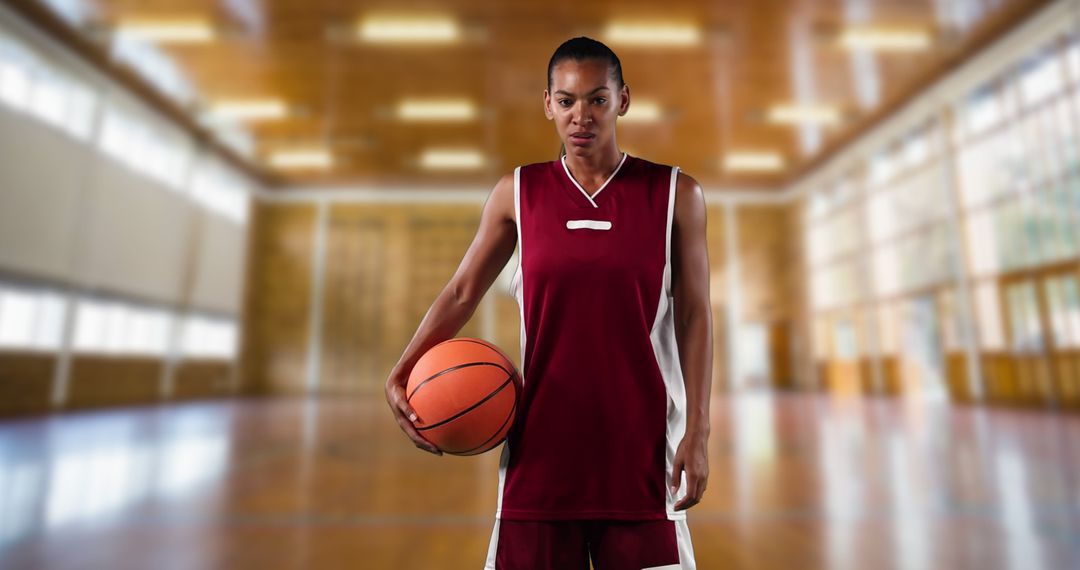 Focused Female Basketball Player Holding Ball in Gymnasium - Free Images, Stock Photos and Pictures on Pikwizard.com