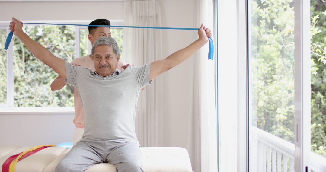 Physiotherapist Helping Senior Man with Resistance Band Exercise - Free Images, Stock Photos and Pictures on Pikwizard.com