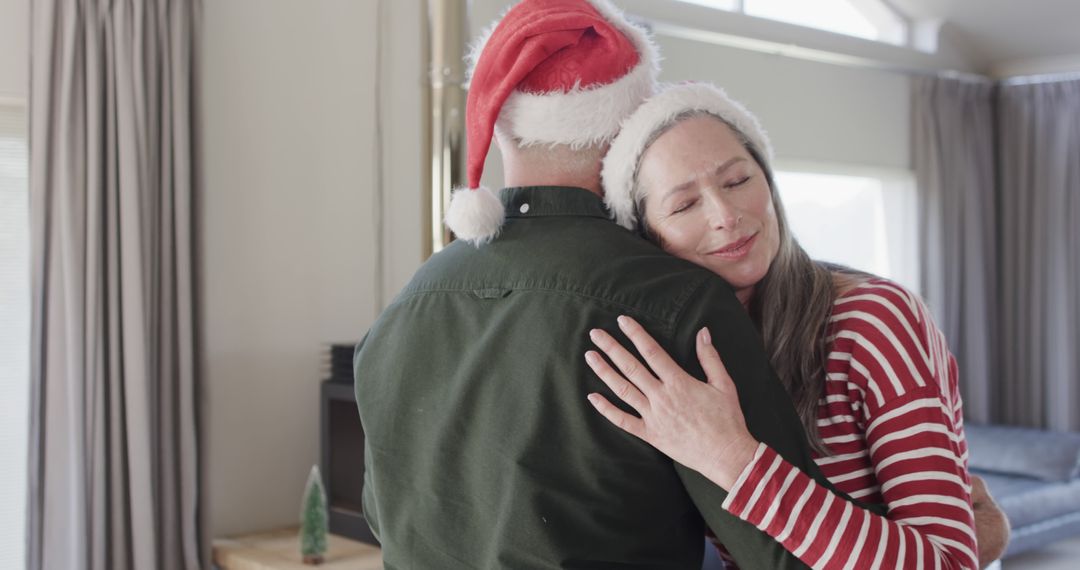 Happy Couple Embracing on Christmas Morning - Free Images, Stock Photos and Pictures on Pikwizard.com