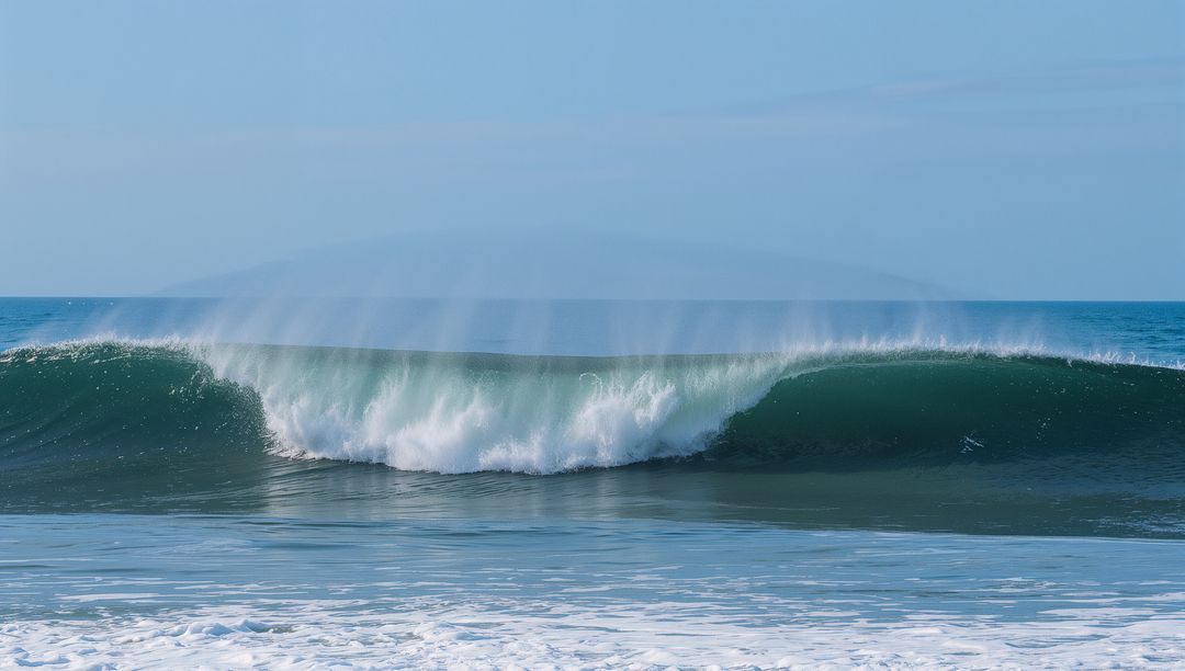 Serene Ocean Wave Breaking Into misty Barrel at Coastline