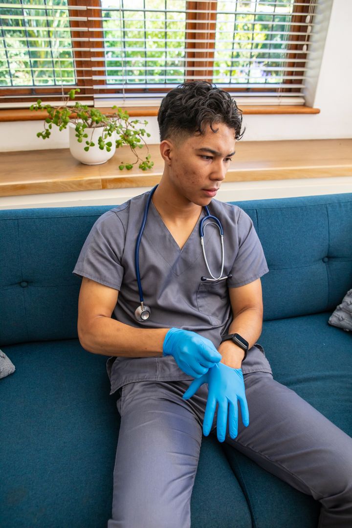 Healthcare Worker Preparing with Medical Glove in Relaxed Setting