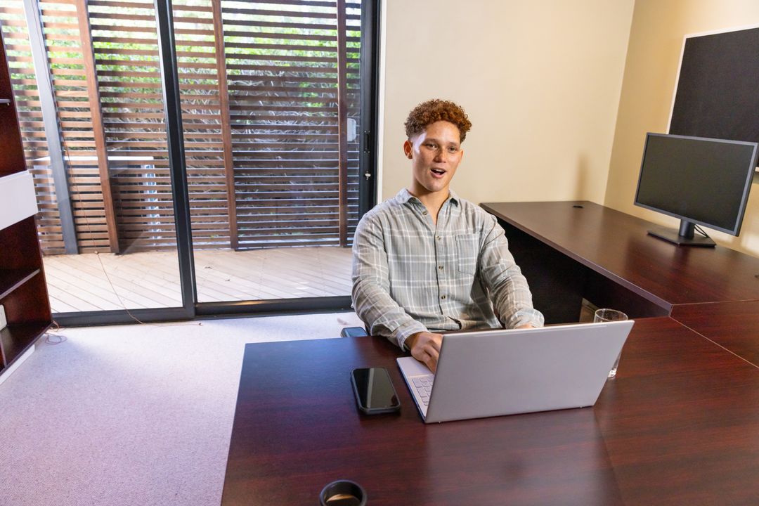 Professional Man Working on Laptop in Modern Office Space