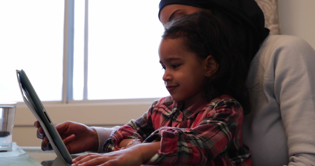 Mother and Daughter Using Tablet in Kitchen, Cozy Togetherness