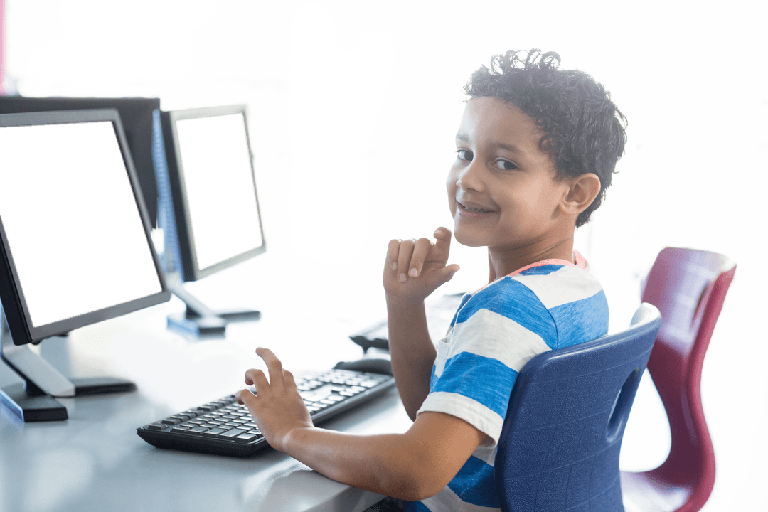 Smiling Boy Using Computer in Classroom with Transparent Monitor - Download Free Stock Images Pikwizard.com