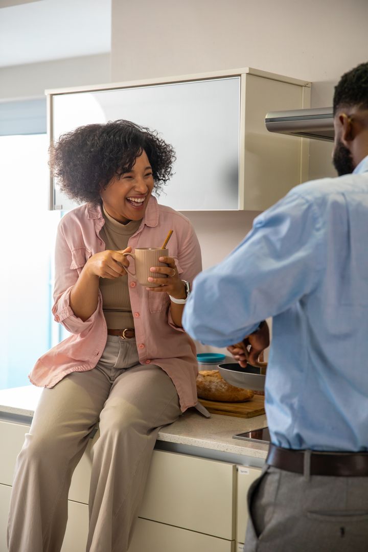 Couple Enjoying Relaxed Conversation in Modern Kitchen Setting