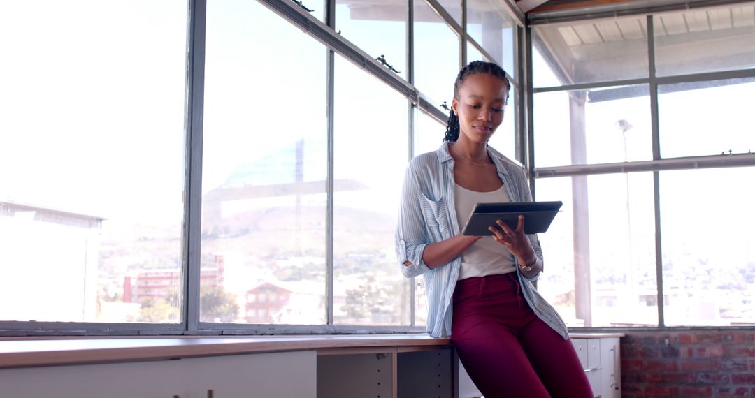 African American Businesswoman Standing by Office Window Using Tablet - Free Images, Stock Photos and Pictures on Pikwizard.com