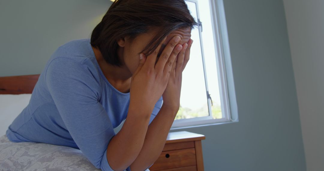 Stressed Woman Sitting on Bed Covering Face With Hands - Free Images, Stock Photos and Pictures on Pikwizard.com