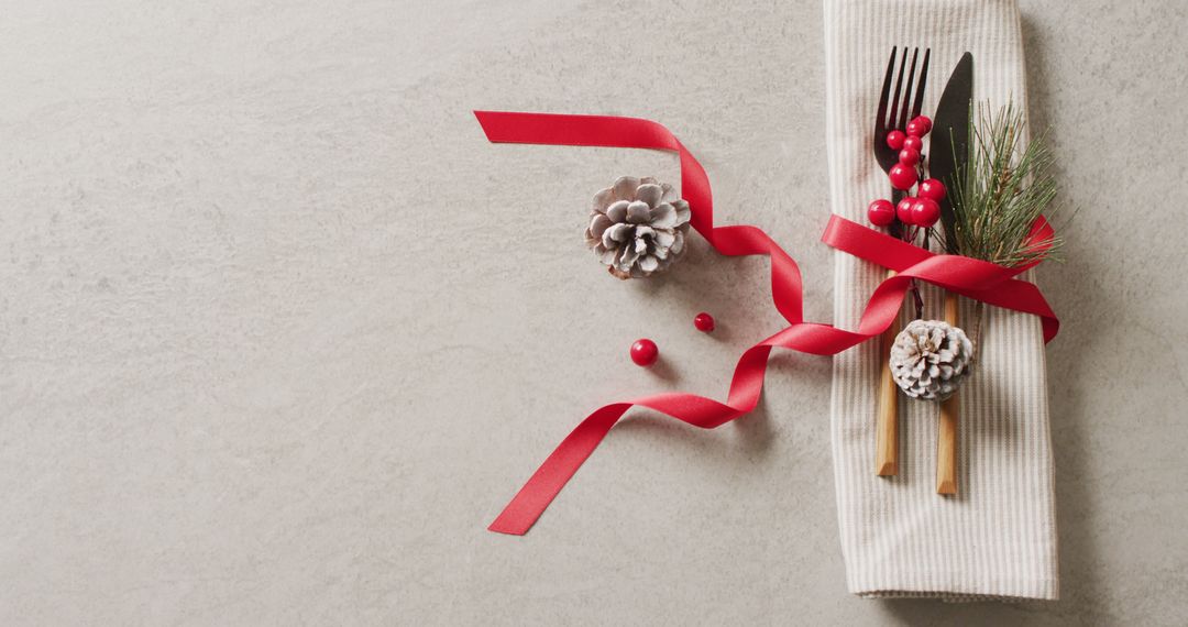 Festive Table Setting with Cutlery and Red Ribbon on Grey Background