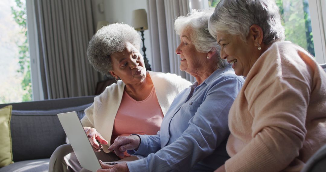 Three Senior Women Using Laptop at Home Laughing and Talking - Free Images, Stock Photos and Pictures on Pikwizard.com