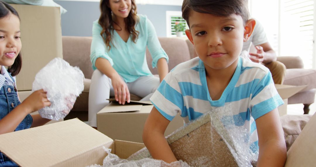 Family Moving into New Home with Boxes and Smiling Children - Free Images, Stock Photos and Pictures on Pikwizard.com