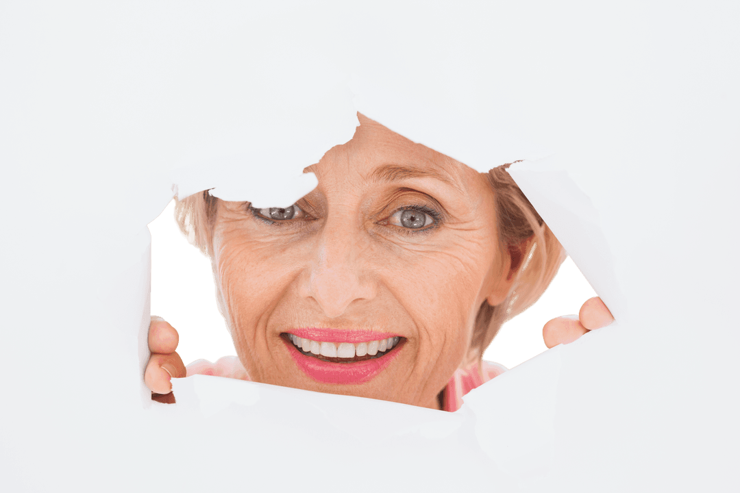 Senior Woman Smiling Through Torn Transparent Surface
