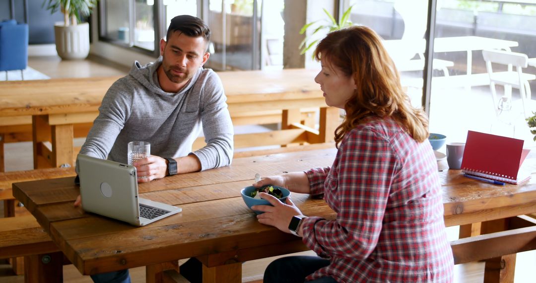 Colleagues Collaborating in Work Cafeteria During Casual Lunch