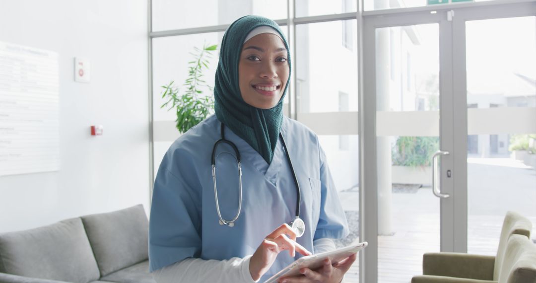 Confident Muslim Nurse Using Digital Tablet in Modern Hospital - Free Images, Stock Photos and Pictures on Pikwizard.com