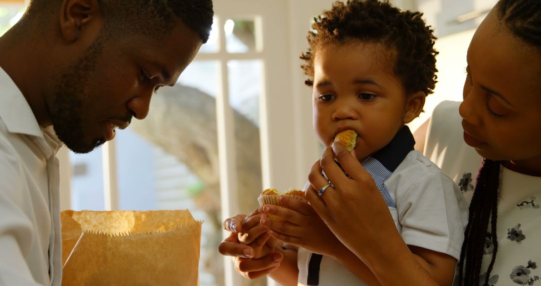 African American Family Enjoying Breakfast with Muffins Together - Free Images, Stock Photos and Pictures on Pikwizard.com