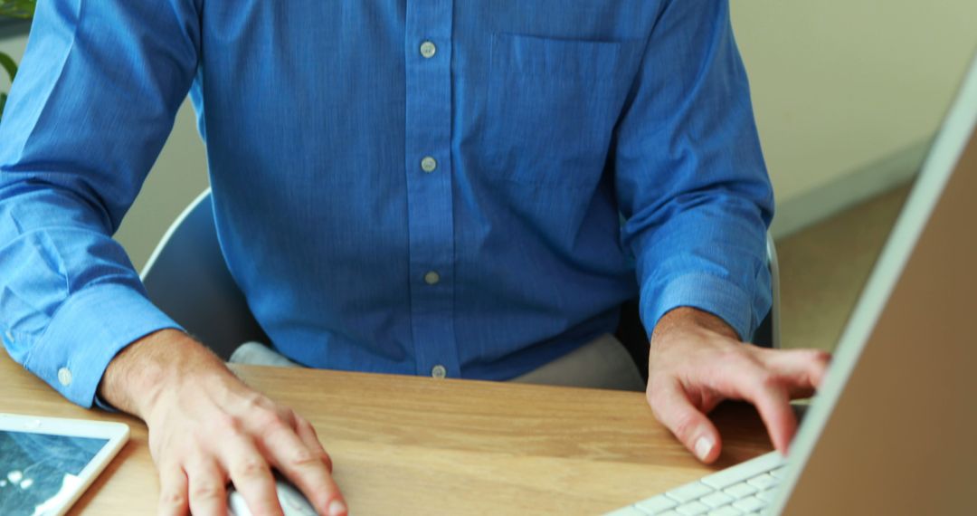 Businessperson Working on Computer at Desk with Tablet - Free Images, Stock Photos and Pictures on Pikwizard.com