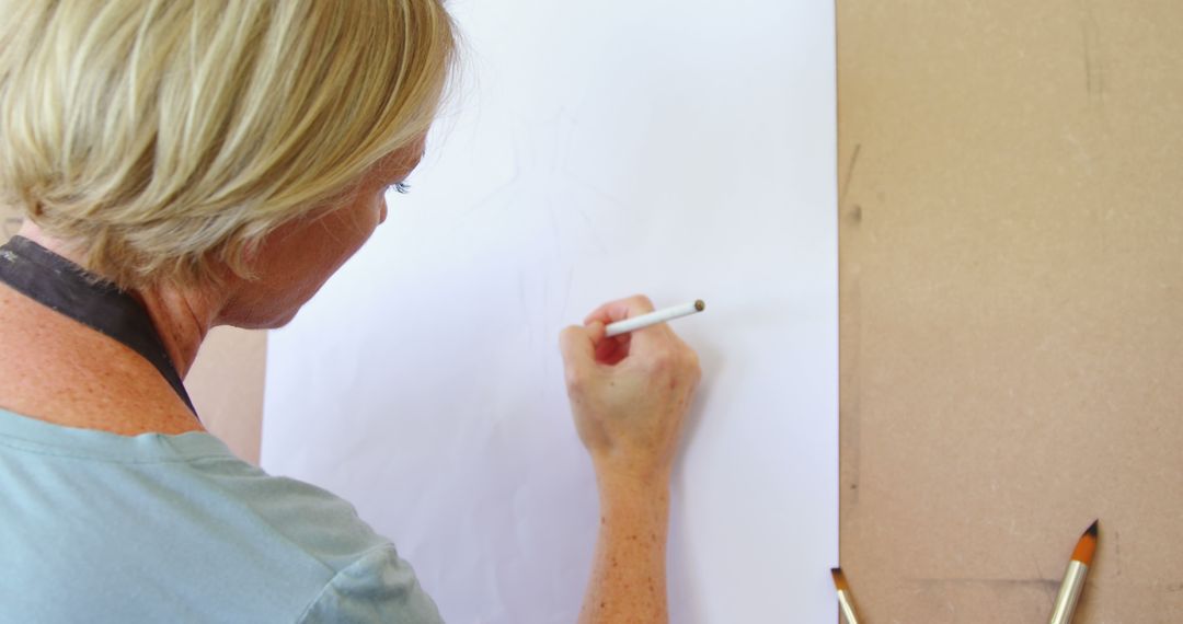 Female Artist Drawing on a Large White Canvas - Free Images, Stock Photos and Pictures on Pikwizard.com