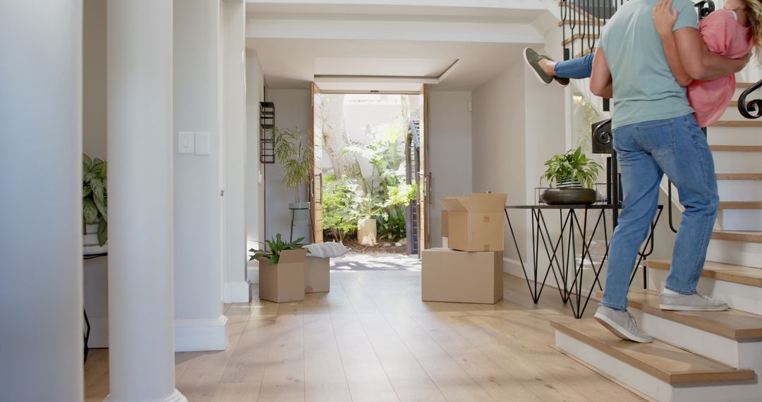 Joyful Couple Celebrating in Their New Home with Moving Boxes