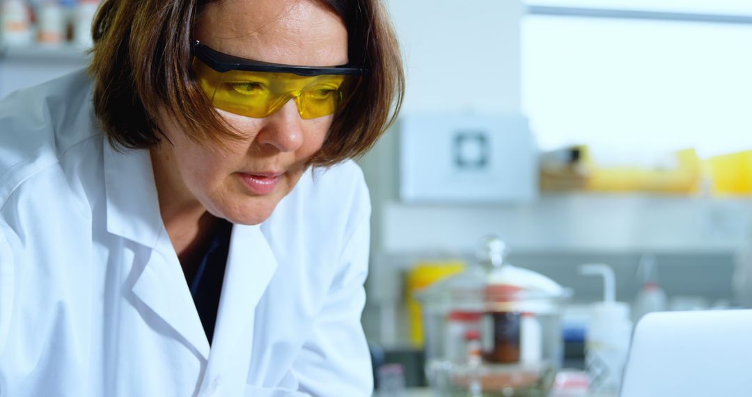 Female Scientist Concentrating in Laboratory with Safety Glasses - Free Images, Stock Photos and Pictures on Pikwizard.com