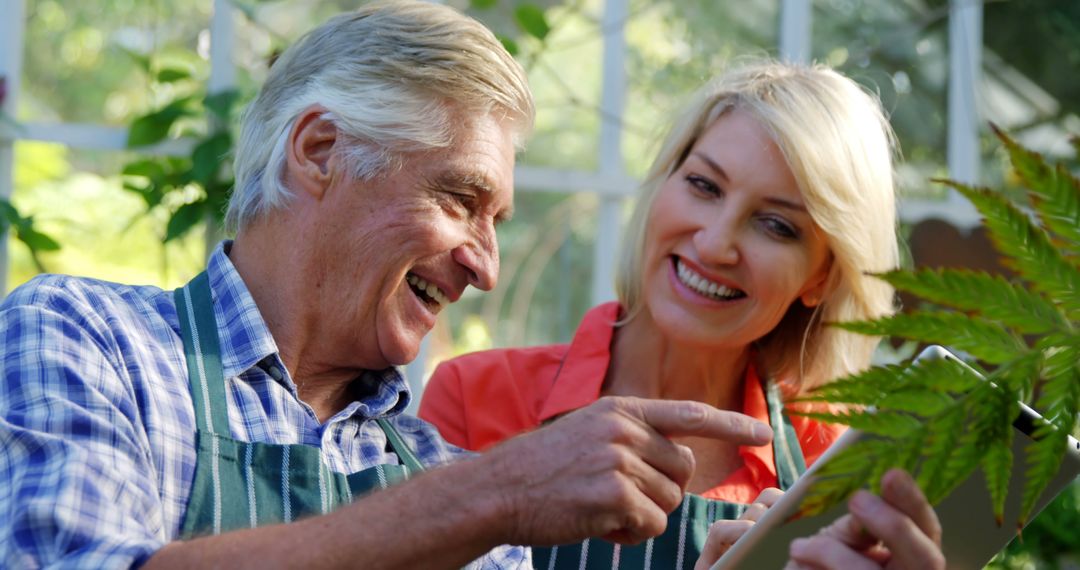 Joyful Senior Couple Gardening Together and Using Digital Tablet for Reference - Free Images, Stock Photos and Pictures on Pikwizard.com