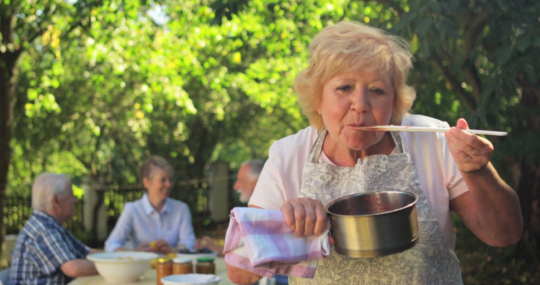 Senior Woman Tasting Homemade Sauce in Garden - Free Images, Stock Photos and Pictures on Pikwizard.com