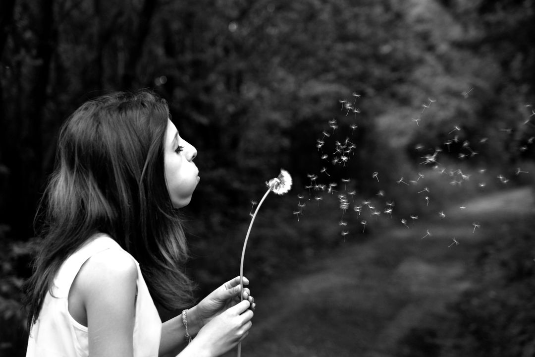 Woman in Tank Top Blowing Dandelion in Grayscale Photography - Free Images, Stock Photos and Pictures on Pikwizard.com