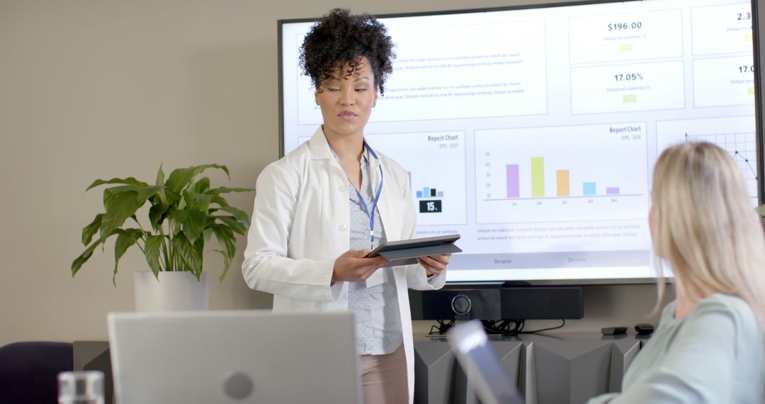 Businesswoman Presenting Data Analysis Report in Office Meeting - Free Images, Stock Photos and Pictures on Pikwizard.com