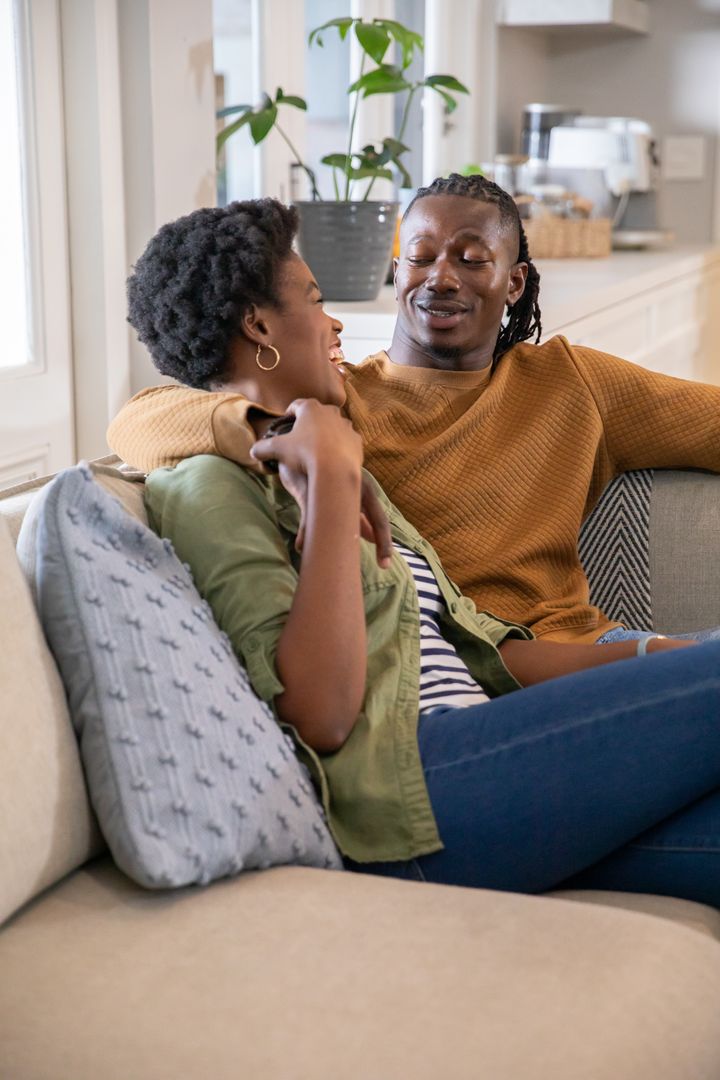 African American Couple Relaxing Together on Sofa at Home