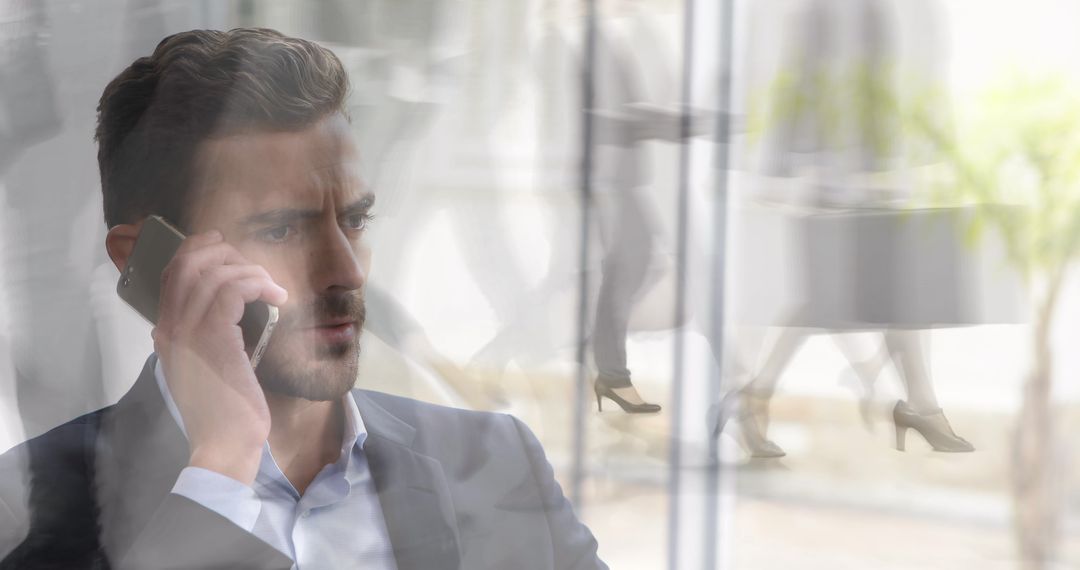 Stressed Businessman on Phone Amid Blurry Office Environment