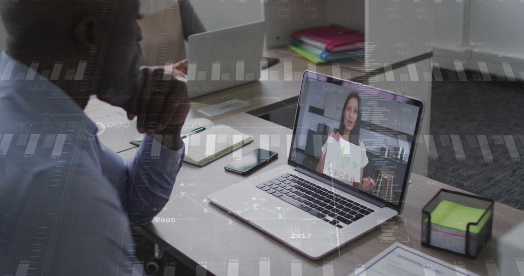 Businessman Engaged in Virtual Meeting with Remote Colleague on Laptop
