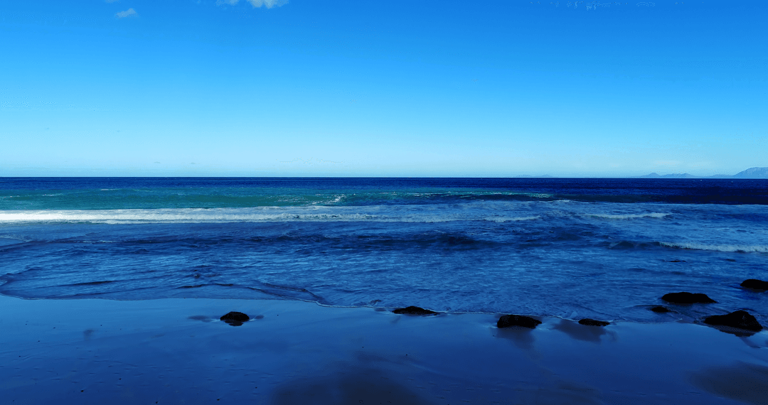 Transparent Blue Ocean with Clear Sky on Peaceful Day