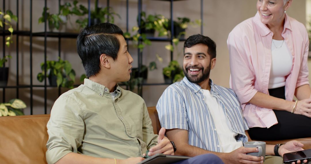 Diverse Team Engaging in Office Lounge Discussion